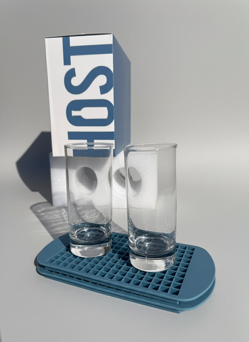 Two clear glasses on a blue tray with a 'HOST' branded box in the background.